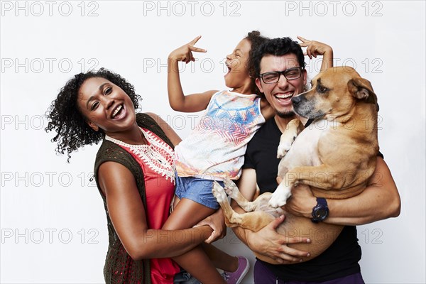 Man and woman holding daughter and dog