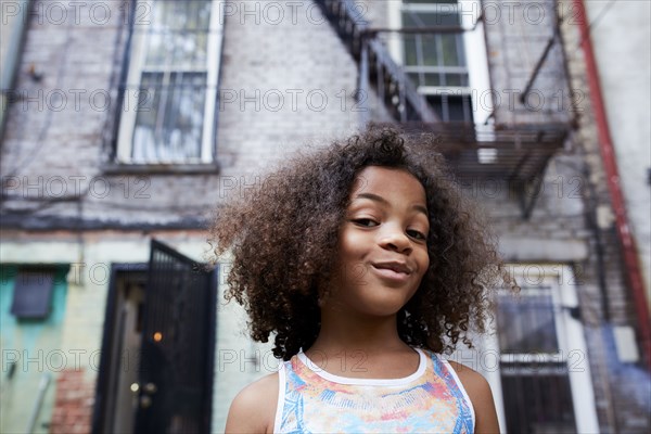 Portrait of smirking Mixed Race girl