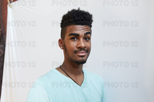 Portrait of smiling Black man raising eyebrow