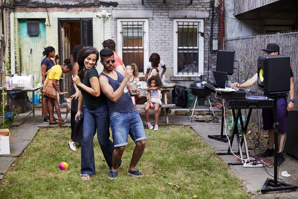 Couple dancing at backyard party