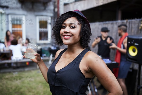 Portrait of smiling Mixed Race woman at backyard party
