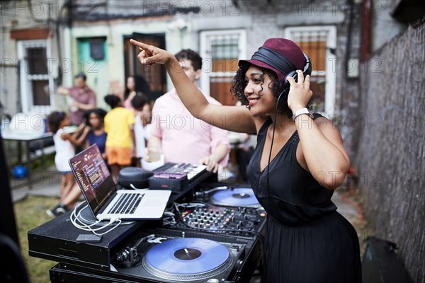 Mixed Race dj playing music at party in backyard