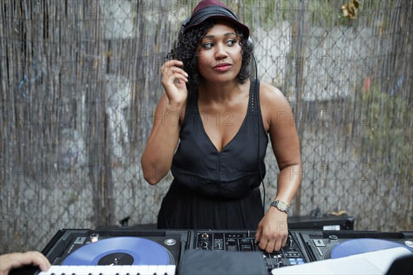 Mixed Race dj playing music in backyard