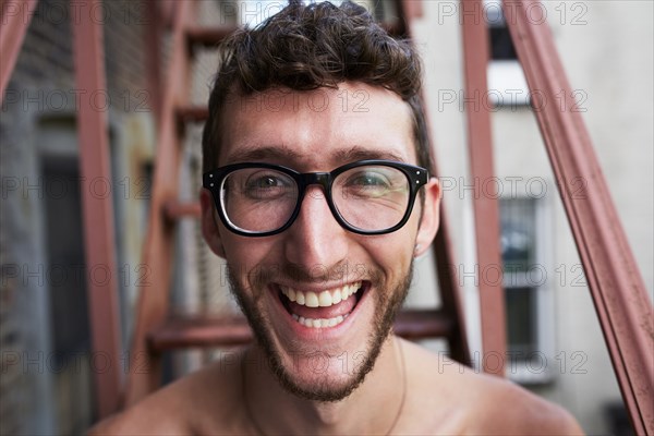 Portrait of Caucasian man on urban fire escape