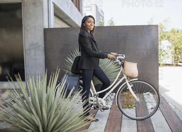 Woman standing with bicycle