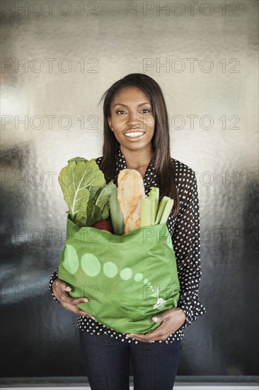 Woman carrying bag of groceries