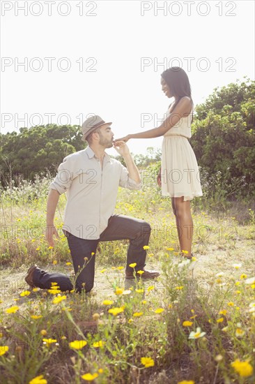 Man kissing girlfriend's hand