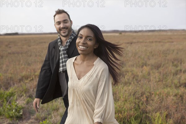 Couple walking in field