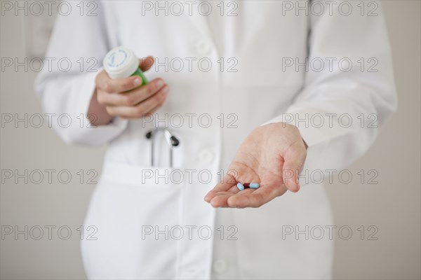 Doctor holding handful of pills