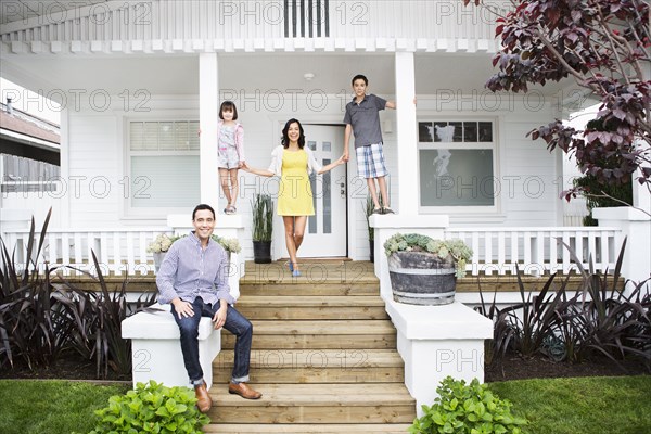 Family smiling together on porch