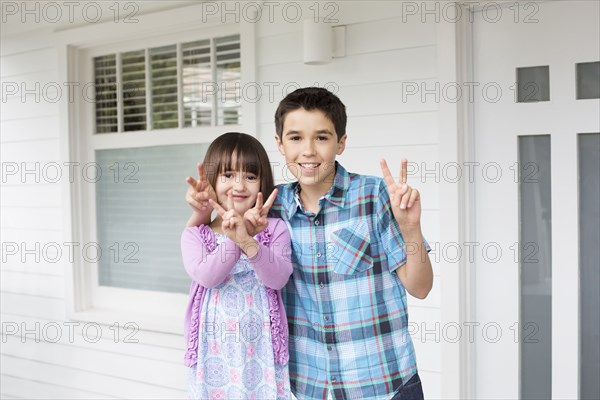 Caucasian children making peace signs