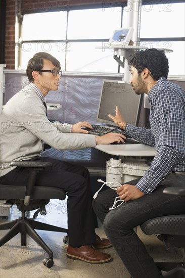 Businessmen talking in office