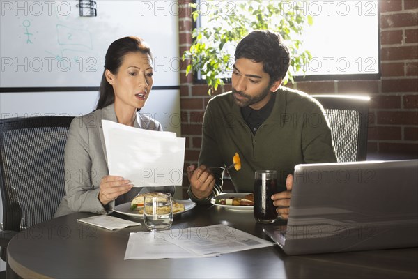 Business people working over lunch