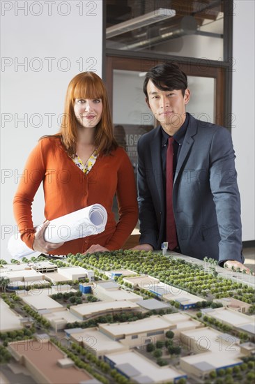 Business people examining scale model