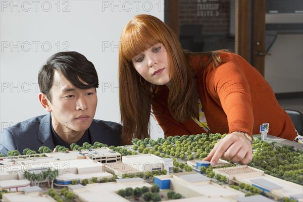 Business people examining scale model