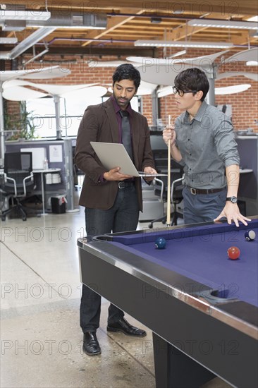 Businessmen talking in office lounge area