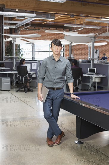 Businessman standing in office lounge area