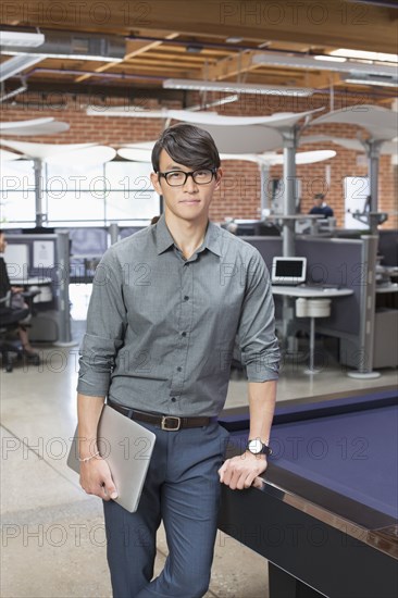 Businessman standing in office lounge area