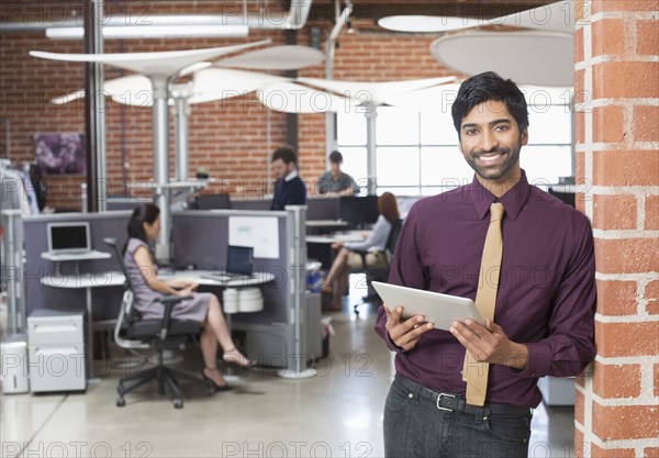 Businessman holding digital tablet in office