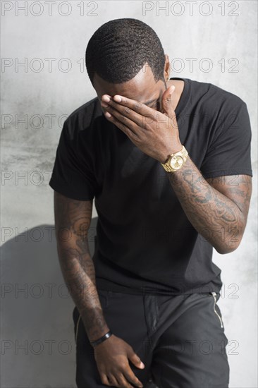 African American man holding his forehead