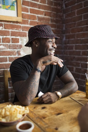 African American man laughing in restaurant