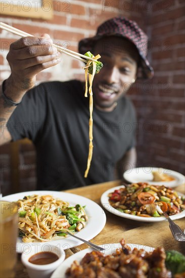 African American man eating at restaurant