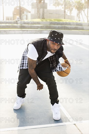 African American man playing on basketball court