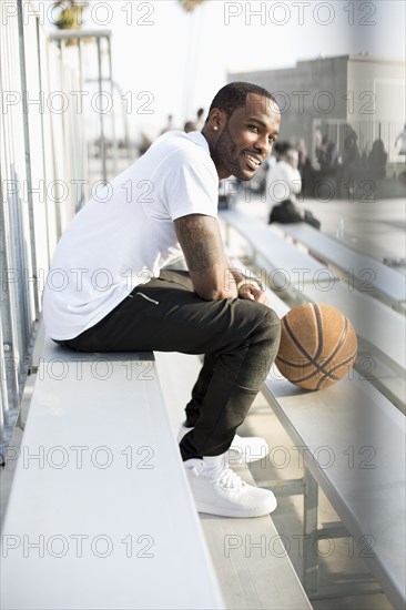 African American man sitting in bleachers