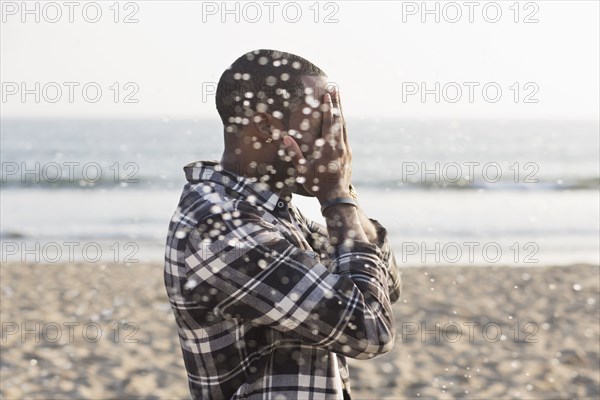 African American man playing on beach