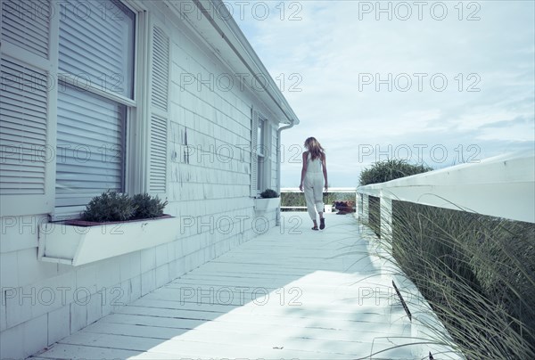 Caucasian woman walking on porch