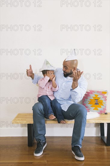 African American father and son playing on bench