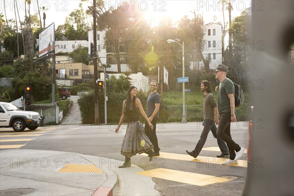 Friends walking in city crosswalk