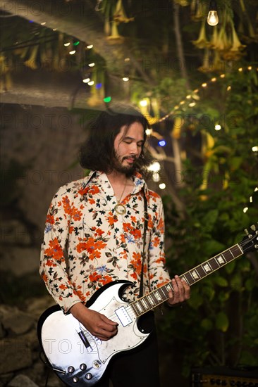 Man with beard playing guitar