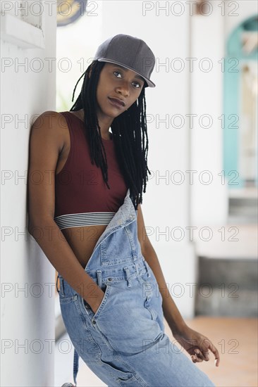 Casual Mixed Race woman leaning on wall