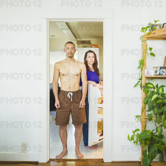 Couple standing in kitchen together