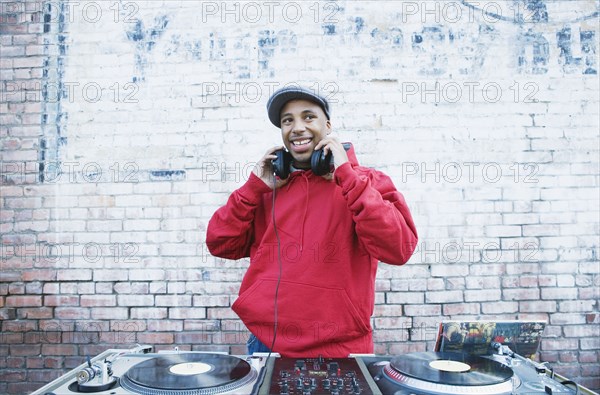 Teenage boy using turntables and headphones