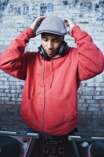 Teenage boy using turntables and headphones