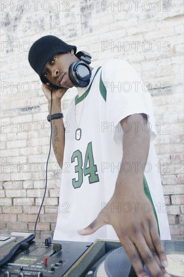 Teenage boy using turntables and headphones