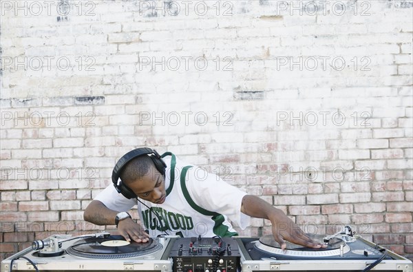 Teenage boy using turntables and headphones