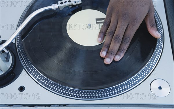 Man spinning vinyl on a turntable