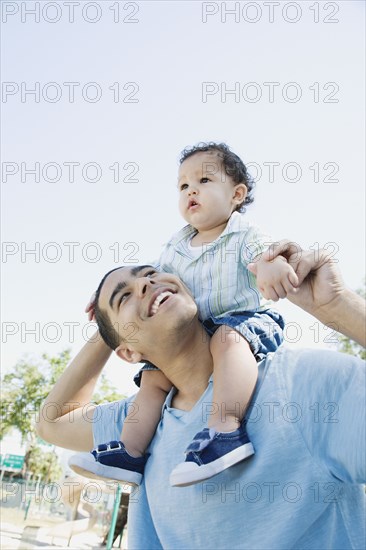 Young African father with baby on shoulders