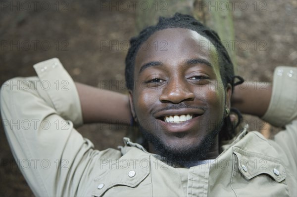 Portrait of African man laying on ground