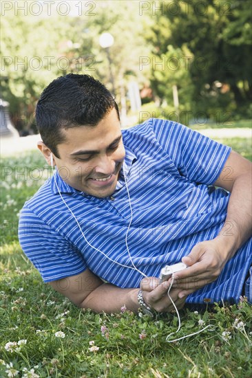 Indian man listening to mp3 player