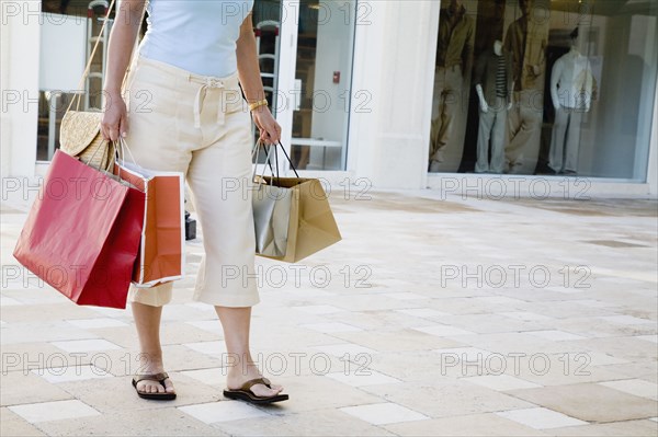 Hispanic woman carrying shopping bags