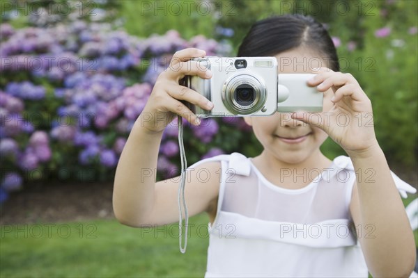 Mixed Race girl taking photograph