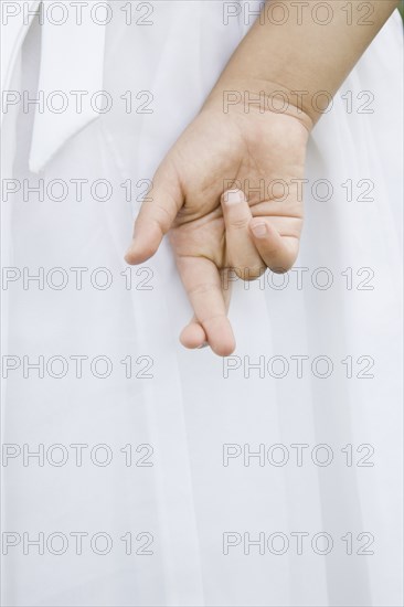 Mixed Race girl with fingers crossed