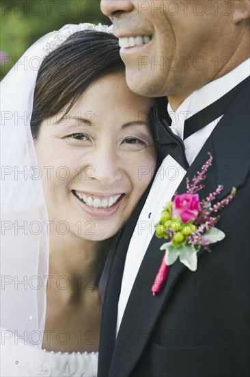 Asian newlyweds hugging