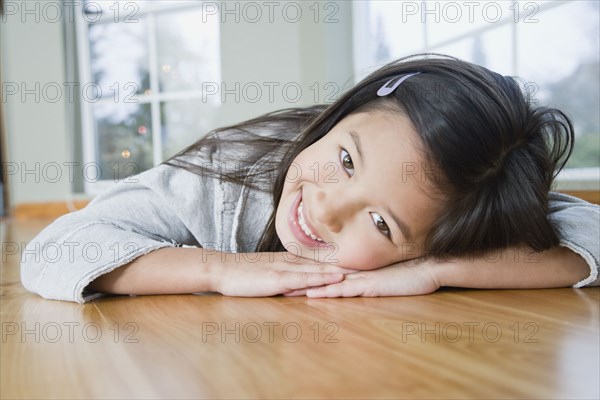 Mixed Race girl resting head on hands