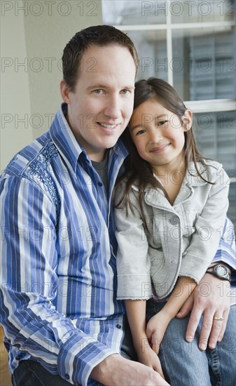 Mixed Race father and daughter hugging