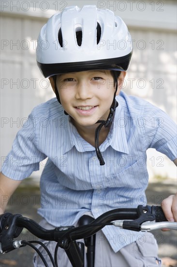 Asian boy riding bicycle
